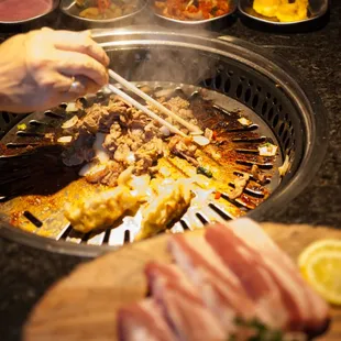 a person cooking food on a grill