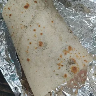 a burrito wrapped in aluminum foil
