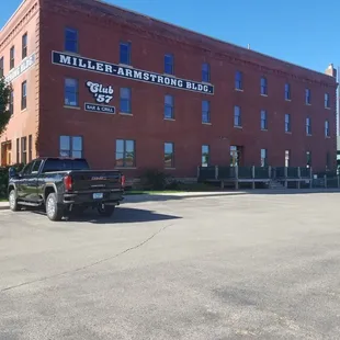 a truck parked in front of a brick building