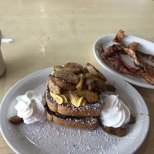 Fall pumpkin GF French Toast with cinnamon apples added on top. And side of bacon!