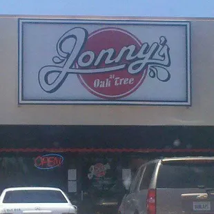 two cars parked in front of the store