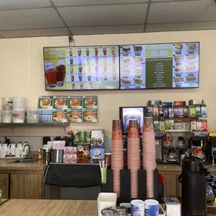 a coffee shop with menus on the wall