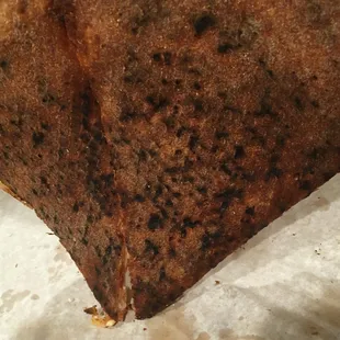 A large Quattro Formarggi all burnt and covered with ashes at the bottom ! A 40 year family tradition they claim , yeah right!