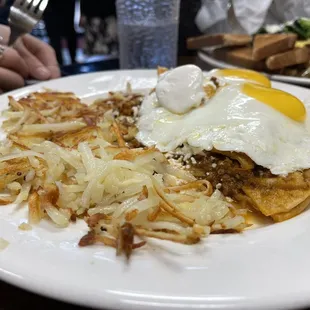 Chilaquiles with sunny side up eggs and hash browns