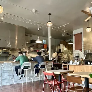 a restaurant with people sitting at tables