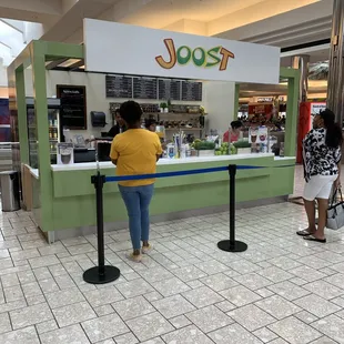 a woman standing in front of a food counter