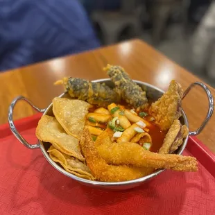 a bowl of food on a red tray