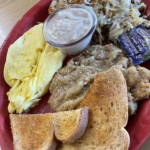 Country fried steak and eggs with the gravy on the side
