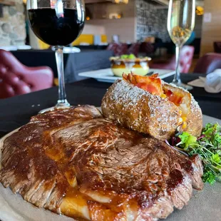 steak and baked potatoes with a glass of wine