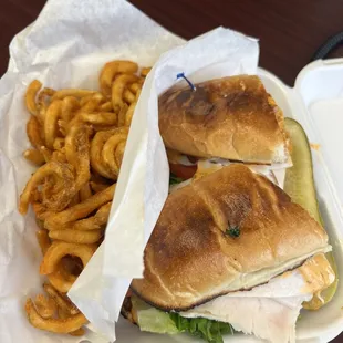 Turkey Club on a toasted roll with chipotle sauce and pepper Jack cheese. Served with curly fries.