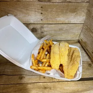 a basket of fried fish and fries