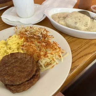 Biscuit and gravy meal with hash browns.