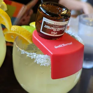 a margarita with a jar of honey on top