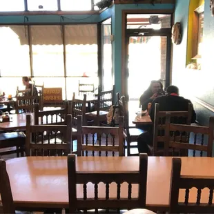people sitting at tables in a restaurant