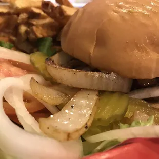 a hamburger with onions and lettuce