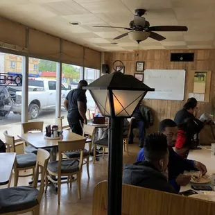 people sitting at tables in a restaurant
