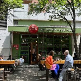 people sitting at tables outside