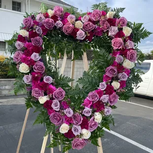 Heart with purple roses, lilac roses, white roses 
Light purple carnations and dark purple carnations