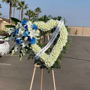 White funeral heart with blue roses