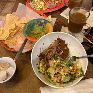 Beef taco salad and guacamole with chips