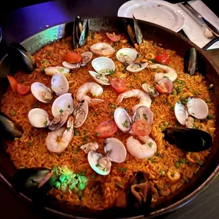 a large pan of seafood and rice