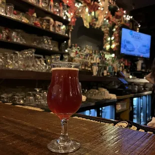 a glass of beer on a bar