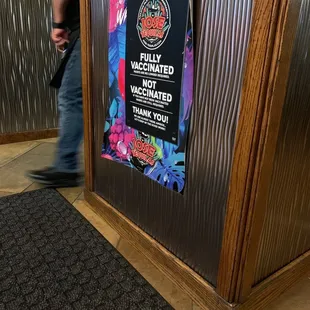 a man walking past a sign