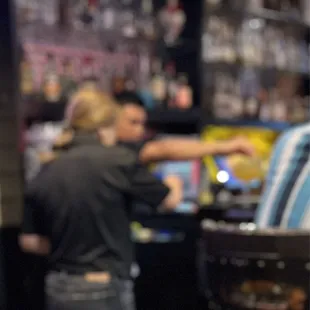 Servers using their hands  to put straws and fruit 'in' drinks