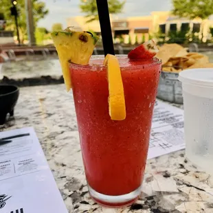 a bloody drink with a pineapple garnish