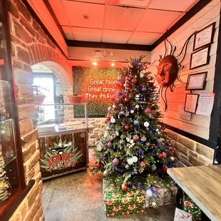 a decorated christmas tree in a restaurant