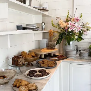 a kitchen counter with a variety of baked goods