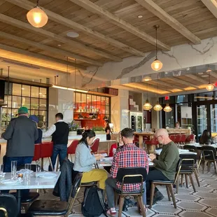 people sitting at tables in a restaurant