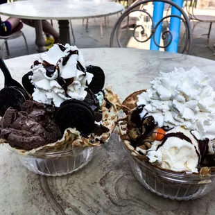 two ice cream sundaes on a table