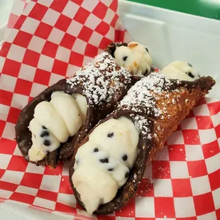 Two beautiful chocolate dipped cannolis!