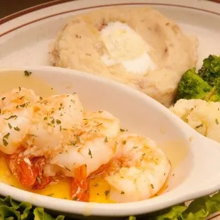 Broiled shrimp scampi dinner with garlic mashed potato and fresh sautéed vegetables.
