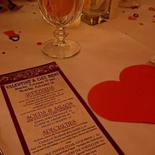 a table setting with a menu and utensils