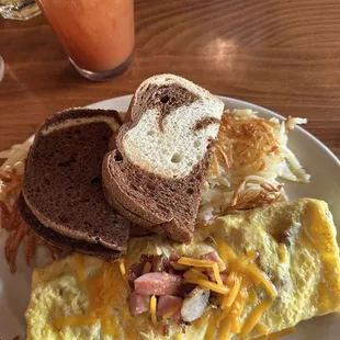 Cheese omelet with ham, sausage, and bacon.