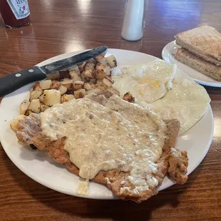 Country Fried Steak,Eggs Medium and breakfast potatoes.