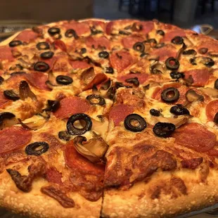 a pizza with pepperoni and olives
