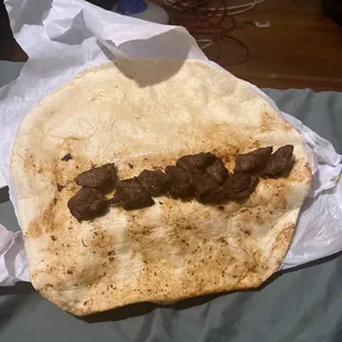 a pita with meat on it