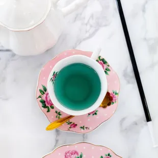 a plate of sandwiches and a cup of tea