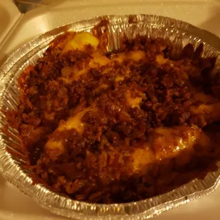 a piece of pizza in a foil pan