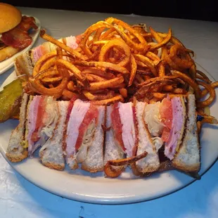 Original club sandwich  turkey, Ham, tomato  Lettuces white/yellow American cheese served in triples Texas toast