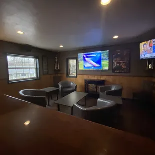a view of a living room with couches and a flat screen tv