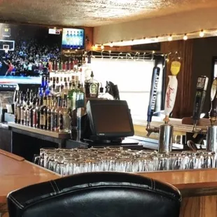 a bar with a lot of glasses on the bar