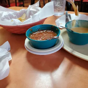 a person dipping sauce into a bowl