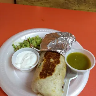 a burrito with salsa and guacamole