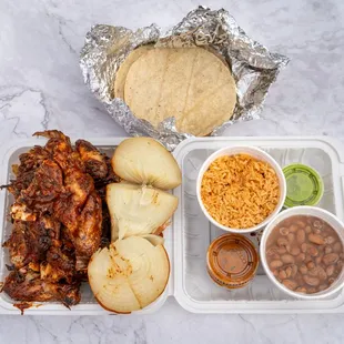 a lunch of pulled pork, beans, tortillas, and rice