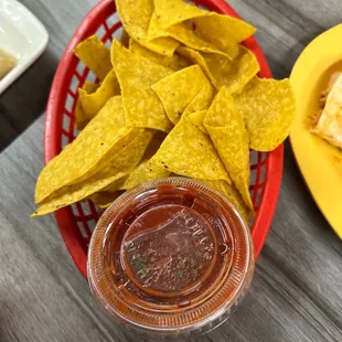 a basket of chips and salsa