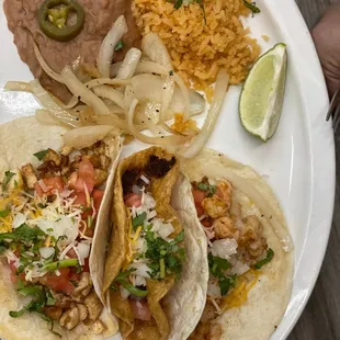 Soft flour chicken and Shrimp taco on either end, with crunchy chorizo taco in the middle + side of rice and beans